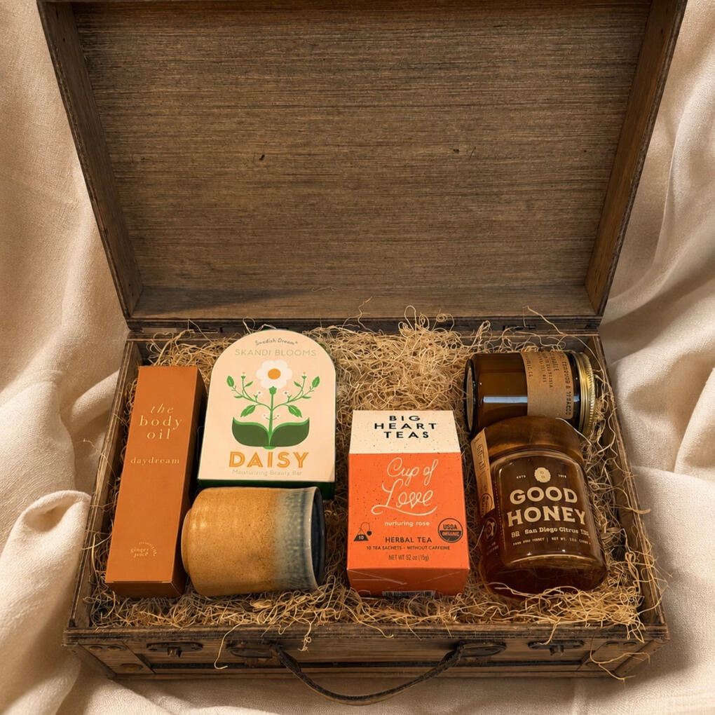 A curated COAH gift box of artisan goods in a wooden keepsake case